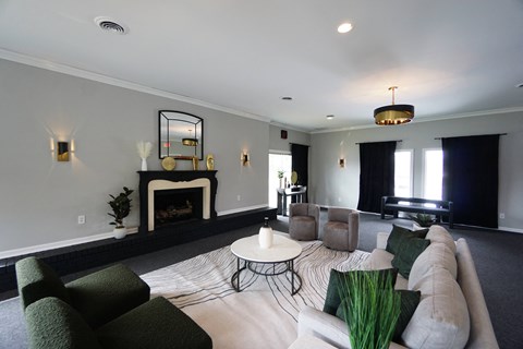 a living room with a couch and chairs and a fireplace